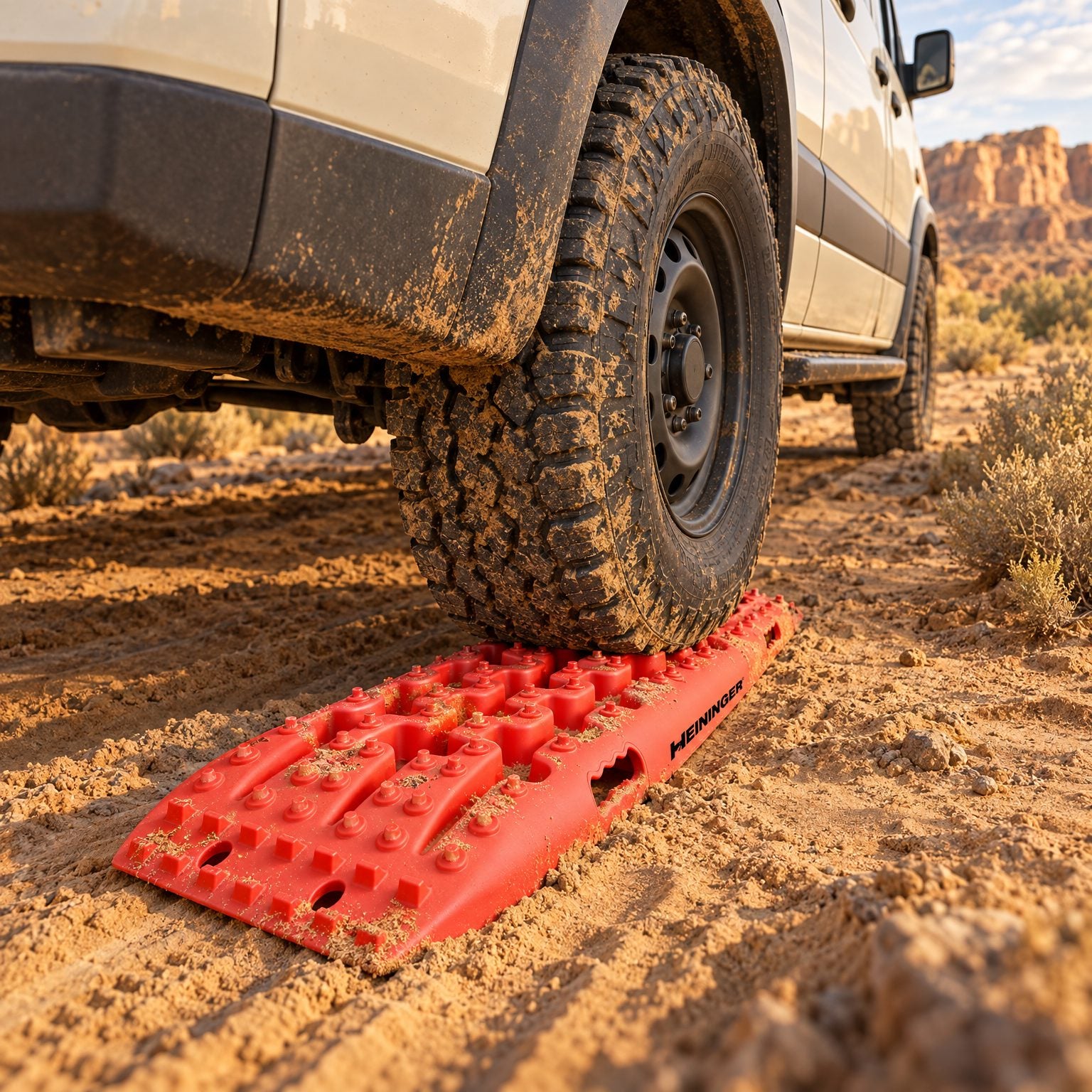 Traction board under a van tire in desert sand